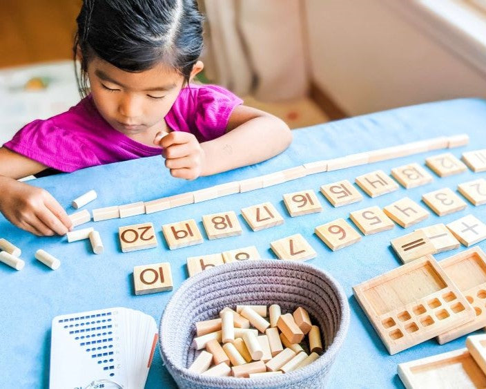 Girl learning how to count using Counting Pegs Math Panels by Little Bud Kids