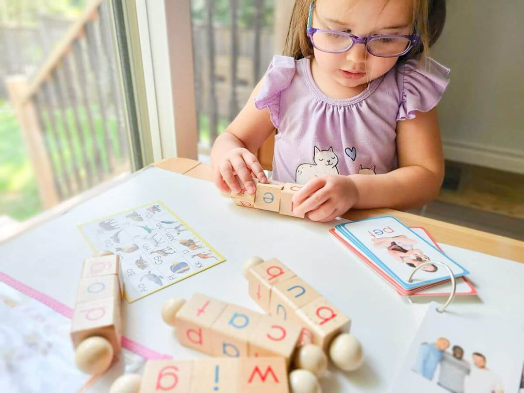 Ecocraftkits & Little Bud Kids - Girl playing with wooden phonics toy