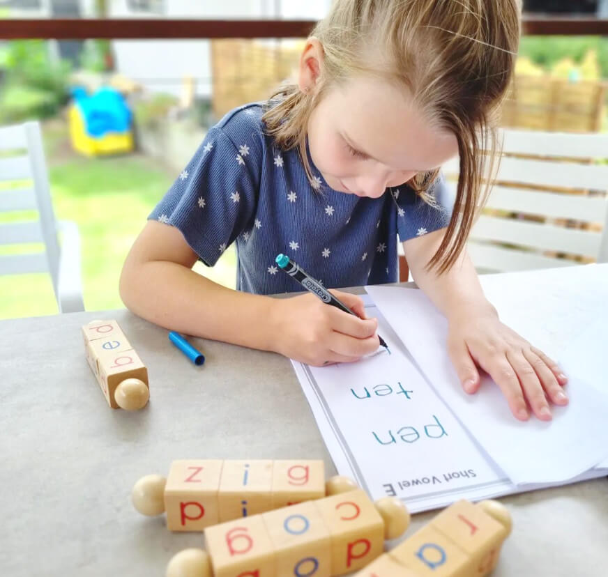 Girl working on CVC Phonics Worksheet Set from Little Bud Kids