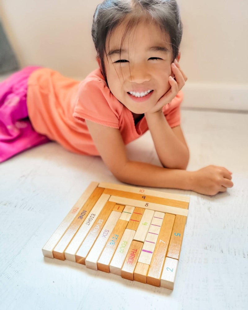 Girl playing with House of Number Buddies Wooden Number Rods Number Bonds Game