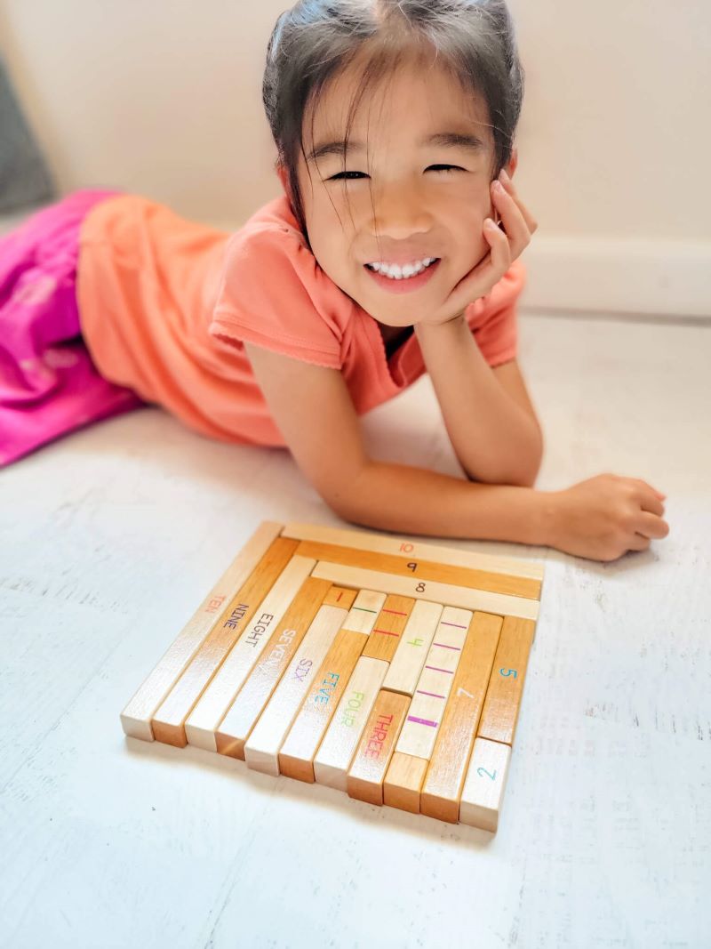 Girl learning addition & subtraction with number rods toy