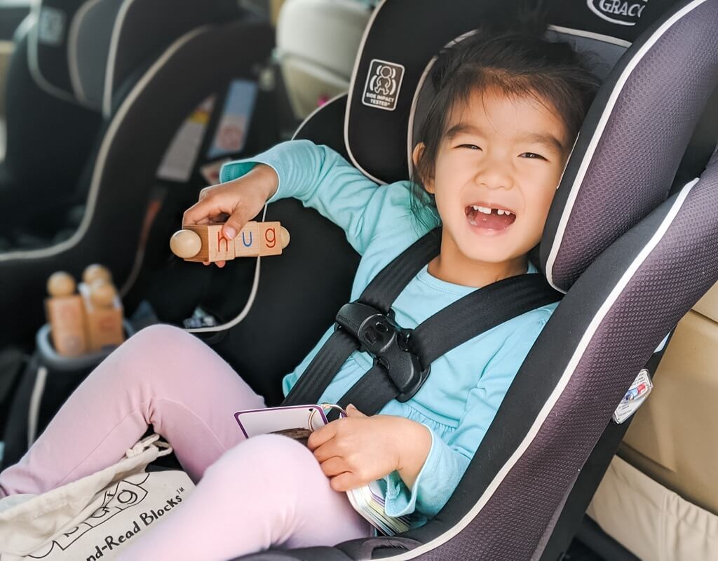 Asian girl practicing reading with CVC Blocks