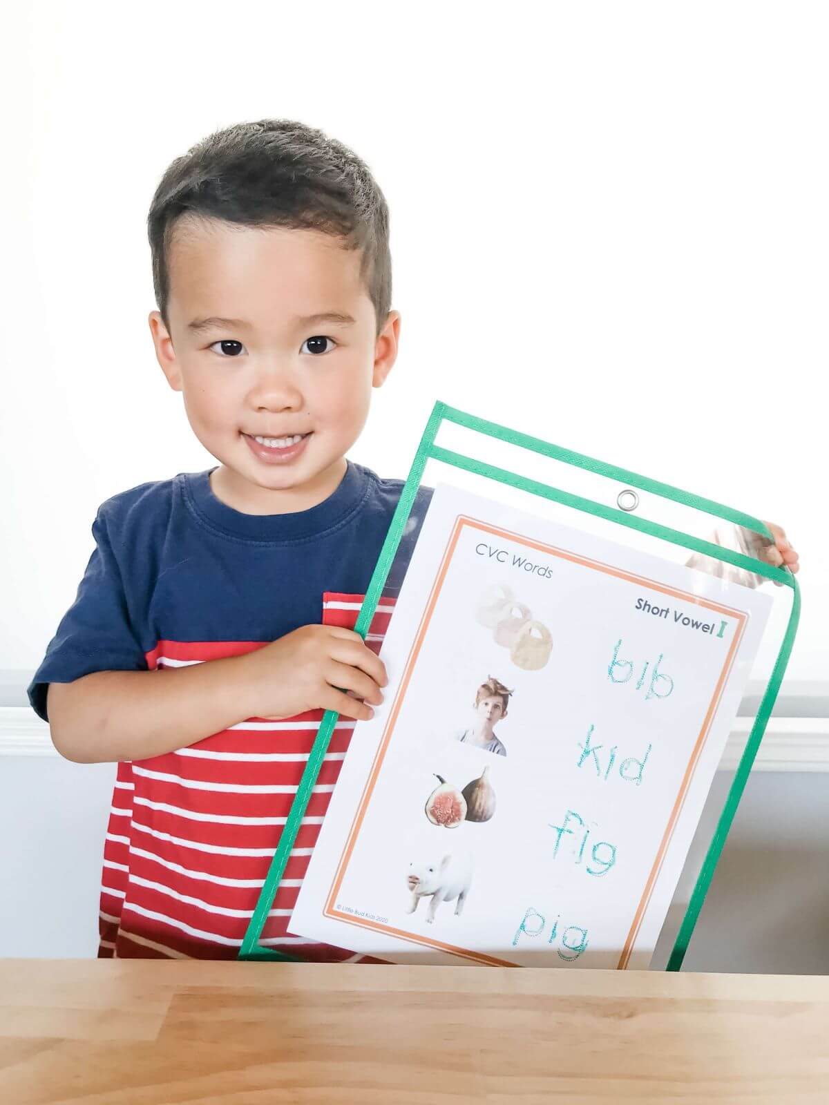Boy using Little Bud Kids Homeschool Supply Kit with CVC Worksheets