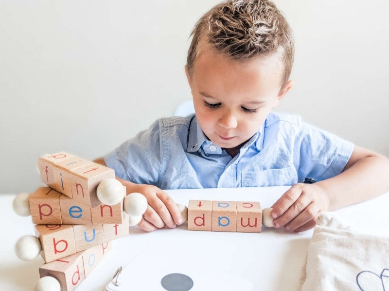 Boy learning to read using Little Bud Kids Spin-and-Read Blocks