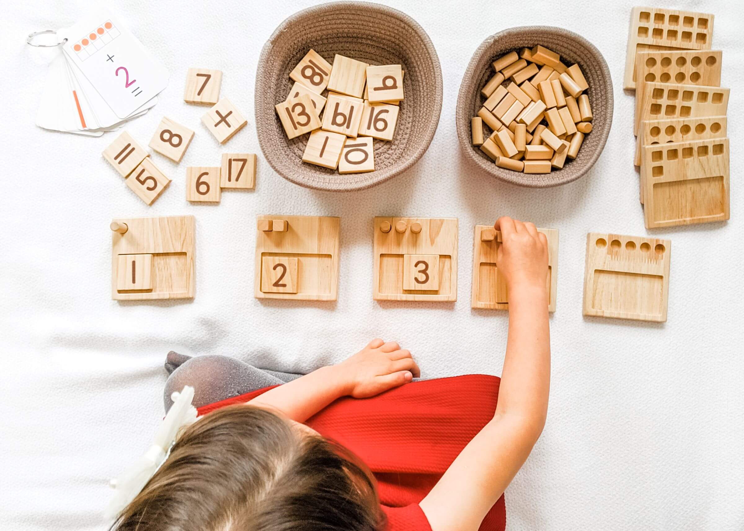 Girl learning how to count using Counting Peg Panels, Montessori Math Pegs