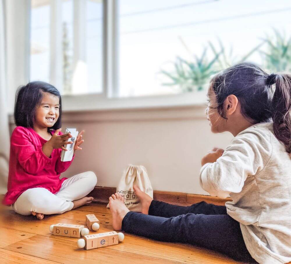 Two girls learning reading together using Little Bud Kids Spin-and-Read Blocks Toy