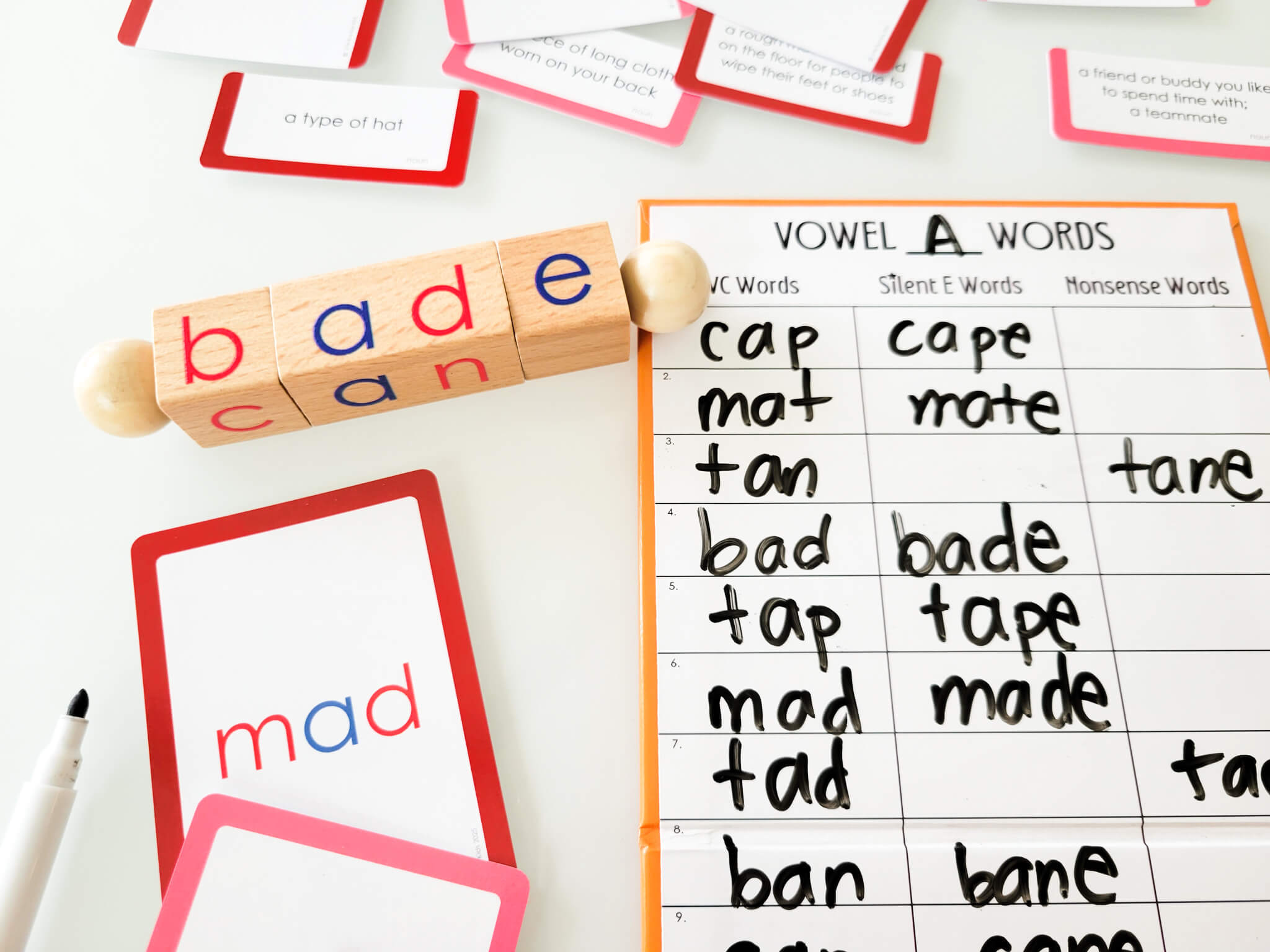 Vowel A word sorting activity with flashcards, wooden blocks, and chart includes CVC, silent E, and nonsense words like mad, bade, and tane for phonics instruction and literacy practice.